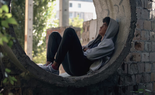 Help Helpers Help Sad lonely student in hoodie sitting alone abandoned building, puberty isolation